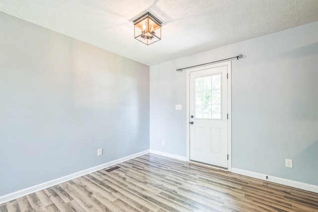 1435 Silver Creek Rd, Lewisburg, TN 37091 - spare room featuring a chandelier, wood finished floors, baseboards, and a textured ceiling
