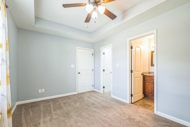 1435 Silver Creek Rd, Lewisburg, TN 37091 - unfurnished bedroom featuring light colored carpet, a tray ceiling, baseboards, and connected bathroom