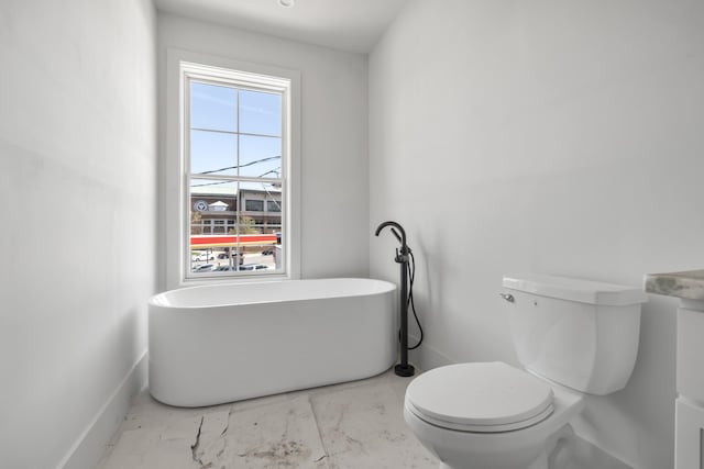 1701 Portland Ave Unit C, Nashville, TN 37212 - full bath with a freestanding bath, marble look tile flooring, toilet, and baseboards