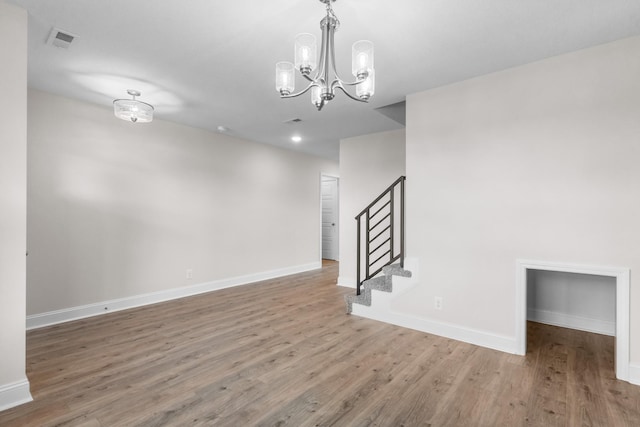 1013 Cherry Acres Dr, Clarksville, TN 37042 - empty room with wood finished floors, a chandelier, baseboards, and stairs