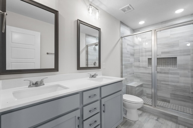 1013 Cherry Acres Dr, Clarksville, TN 37042 - bathroom with toilet, double vanity, a stall shower, and recessed lighting