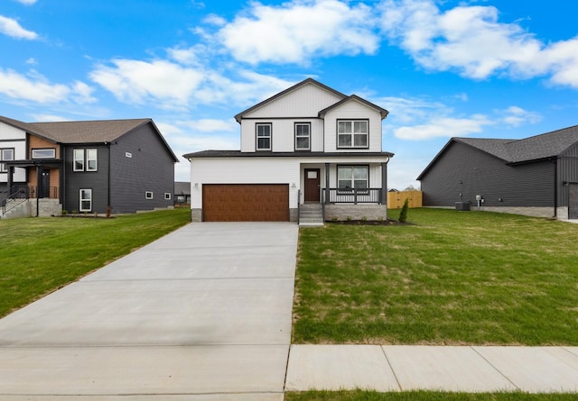 1013 Cherry Acres Dr, Clarksville, TN 37042 - view of front of property featuring concrete driveway, a front lawn, a garage, covered porch, and central AC