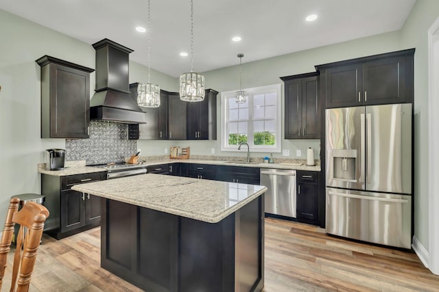 1006 Twilight Dr, Castalian Springs, TN 37031 - kitchen featuring stainless steel appliances, custom exhaust hood, light stone countertops, light wood-type flooring, and recessed lighting