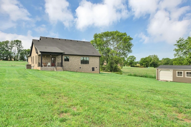 1006 Twilight Dr, Castalian Springs, TN 37031 - back of property with a yard, an outdoor structure, brick siding, a shingled roof, and crawl space