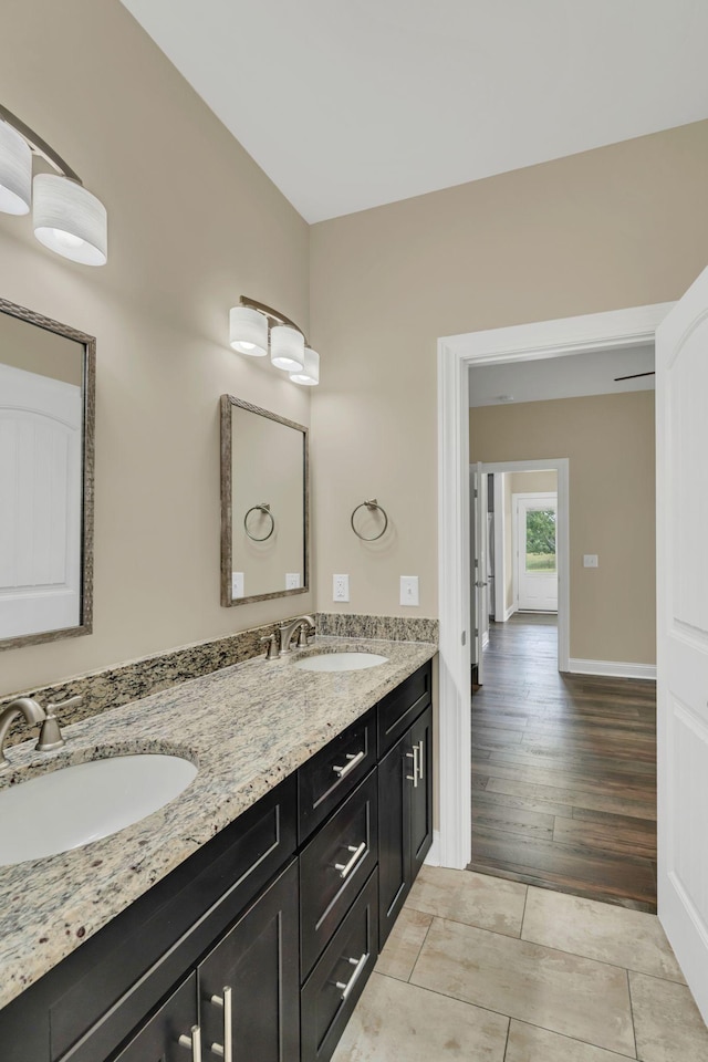 1006 Twilight Dr, Castalian Springs, TN 37031 - full bathroom with double vanity, baseboards, and wood finished floors
