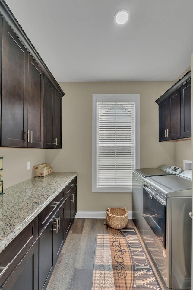 1006 Twilight Dr, Castalian Springs, TN 37031 - washroom featuring cabinet space, washing machine and dryer, wood finished floors, and baseboards