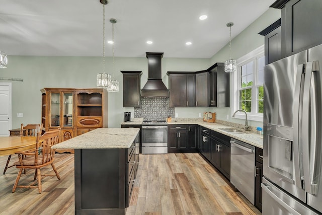 1006 Twilight Dr, Castalian Springs, TN 37031 - kitchen with stainless steel appliances, custom range hood, a sink, a chandelier, and light wood finished floors