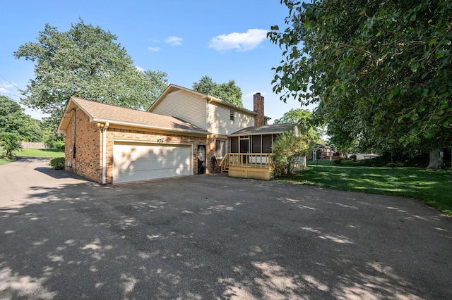 412 Benton Ln, Franklin, TN 37067 - view of front of property with brick siding, a sunroom, driveway, an attached garage, and a chimney