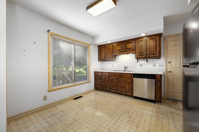412 Benton Ln, Franklin, TN 37067 - kitchen featuring stainless steel dishwasher, a sink, light countertops, baseboards, and light flooring