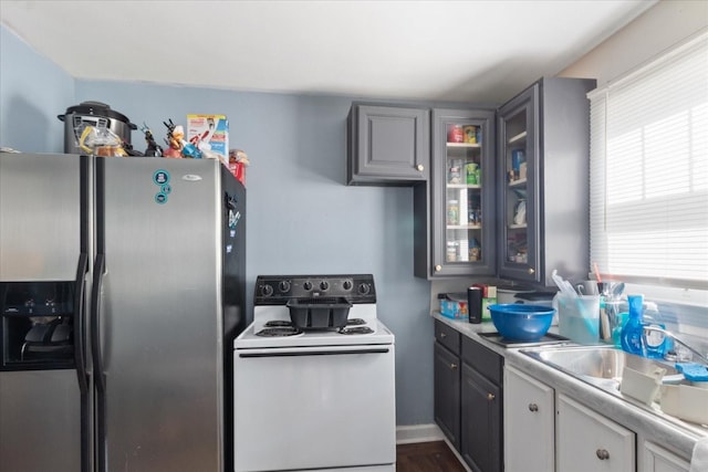 525 Maple St, Lewisburg, TN 37091 - kitchen featuring stainless steel fridge with ice dispenser, white electric range, glass insert cabinets, and light countertops
