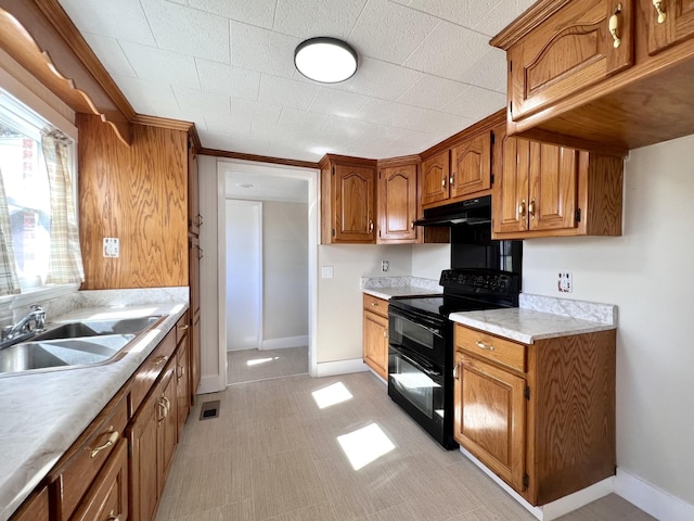 715 Hunt St, Winchester, TN 37398 - kitchen featuring black range with electric stovetop, a sink, under cabinet range hood, brown cabinetry, and light countertops