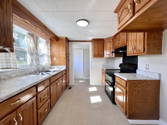 715 Hunt St, Winchester, TN 37398 - kitchen with black electric range oven, under cabinet range hood, brown cabinets, a sink, and light countertops