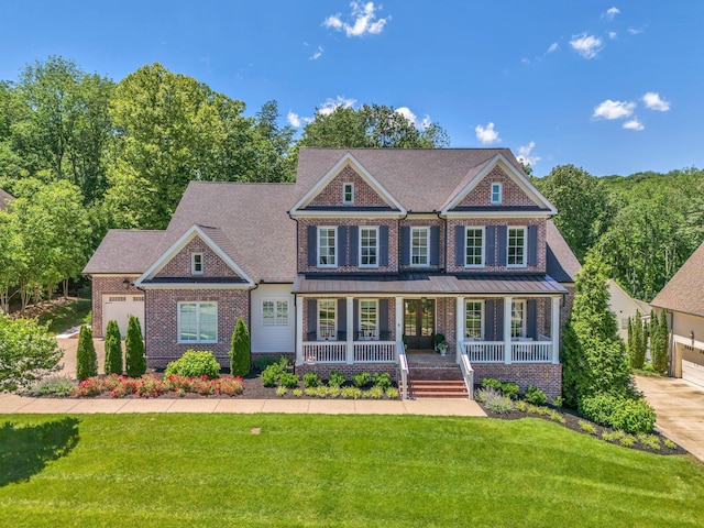 6690 Hastings Ln, Franklin, TN 37069 - colonial inspired home with brick siding, covered porch, a front lawn, and a standing seam roof