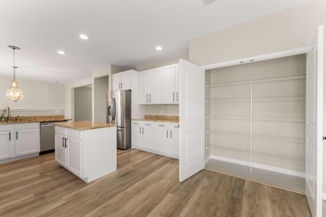 1205 Riverbirch Way, Hermitage, TN 37076 - kitchen with appliances with stainless steel finishes, light stone countertops, light wood-style floors, white cabinetry, and recessed lighting
