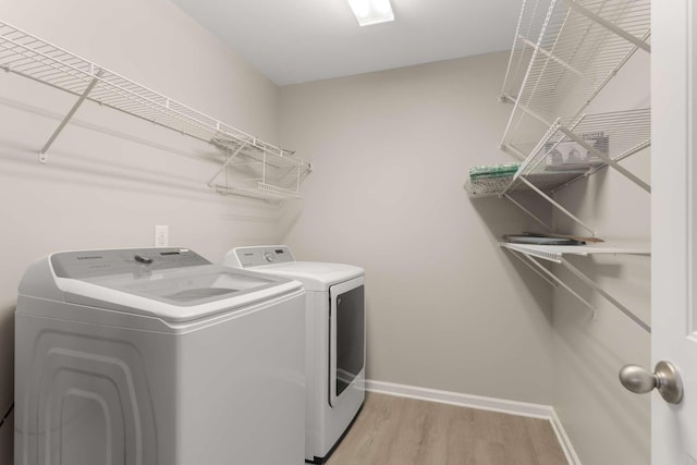 1205 Riverbirch Way, Hermitage, TN 37076 - laundry area with washer and clothes dryer, baseboards, and light wood-style floors