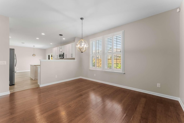 1205 Riverbirch Way, Hermitage, TN 37076 - unfurnished room featuring a chandelier, baseboards, recessed lighting, and dark wood finished floors