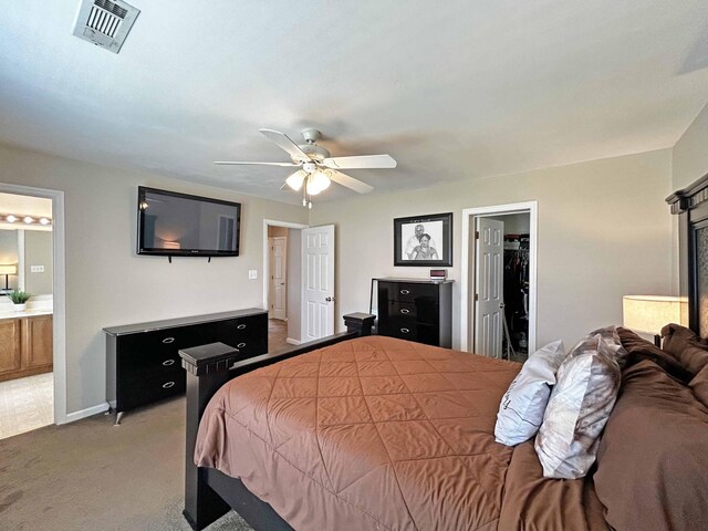 305 Wildwood Dr, Smyrna, TN 37167 - bedroom featuring light carpet, a spacious closet, ensuite bath, a ceiling fan, and baseboards
