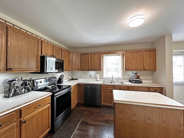305 Wildwood Dr, Smyrna, TN 37167 - kitchen featuring stainless steel appliances, a sink, brown cabinetry, and light countertops