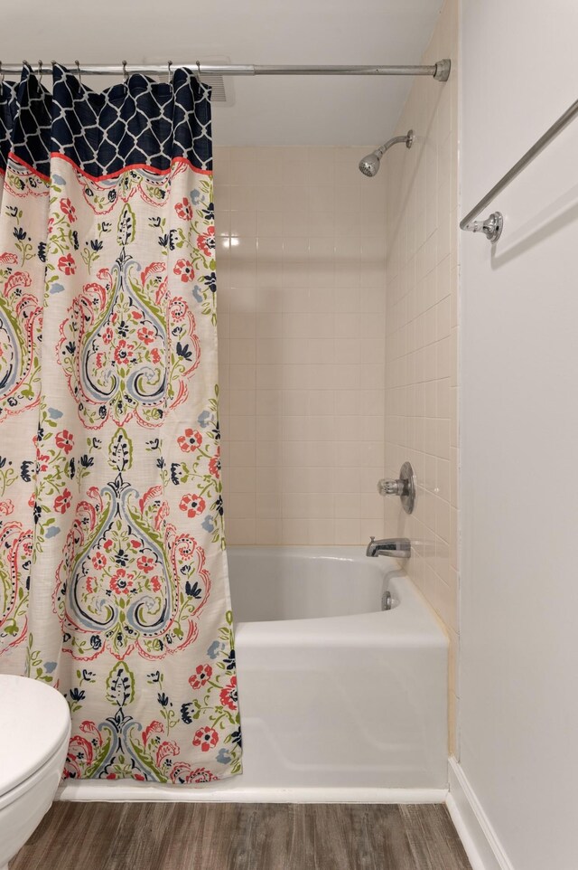 5025 Hillsboro Pike Unit 24K, Nashville, TN 37215 - full bath featuring wood finished floors, shower / bath combo with shower curtain, toilet, and baseboards