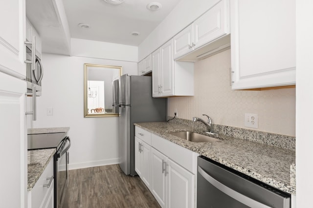 5025 Hillsboro Pike Unit 24K, Nashville, TN 37215 - kitchen with stainless steel appliances, a sink, white cabinetry, dark wood-type flooring, and light stone counters