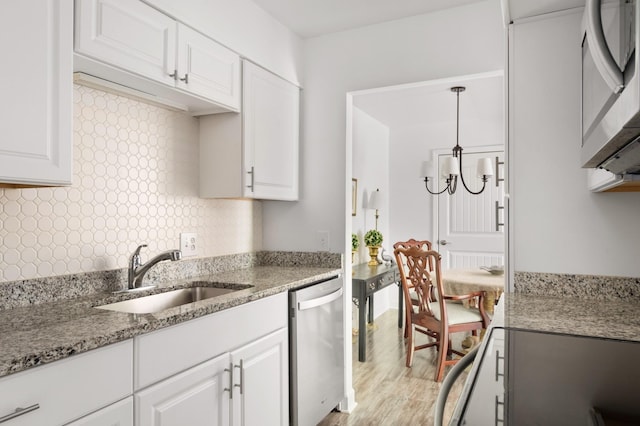 5025 Hillsboro Pike Unit 24K, Nashville, TN 37215 - kitchen with appliances with stainless steel finishes, a sink, white cabinets, light wood-type flooring, and light stone countertops