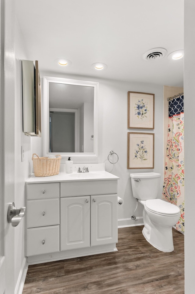5025 Hillsboro Pike Unit 24K, Nashville, TN 37215 - bathroom featuring baseboards, toilet, vanity, wood finished floors, and recessed lighting