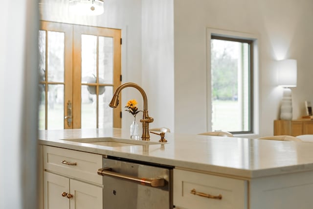 1465 Smith Rd, Lebanon, TN 37087 - kitchen with stainless steel dishwasher, a sink, white cabinets, and light stone counters
