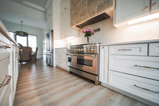 1465 Smith Rd, Lebanon, TN 37087 - kitchen featuring appliances with stainless steel finishes, light wood-type flooring, white cabinetry, and light countertops