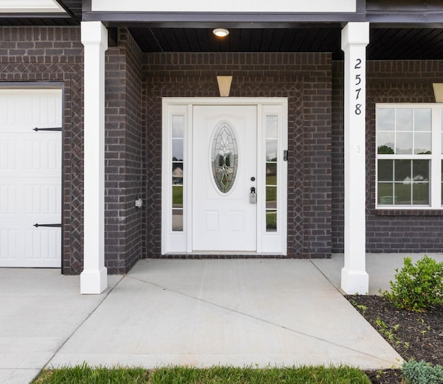 2578 Rafiki Dr, Clarksville, TN 37042 - view of exterior entry featuring brick siding, a garage, and a porch