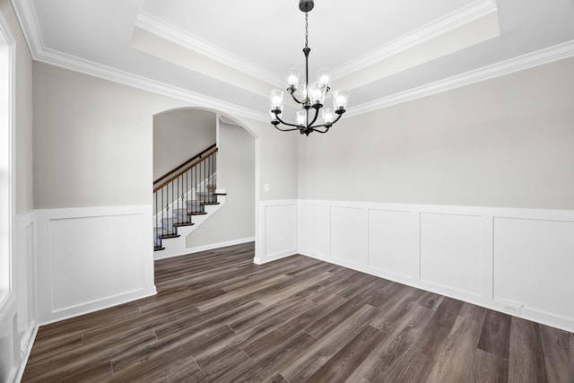 2578 Rafiki Dr, Clarksville, TN 37042 - spare room with arched walkways, a chandelier, dark wood-style flooring, stairs, and a tray ceiling