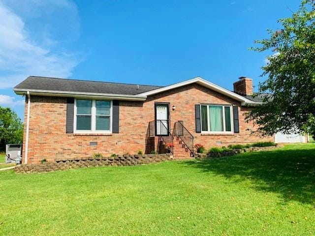 105 Brookview Dr, White House, TN 37188 - ranch-style home with brick siding, a front yard, and a chimney