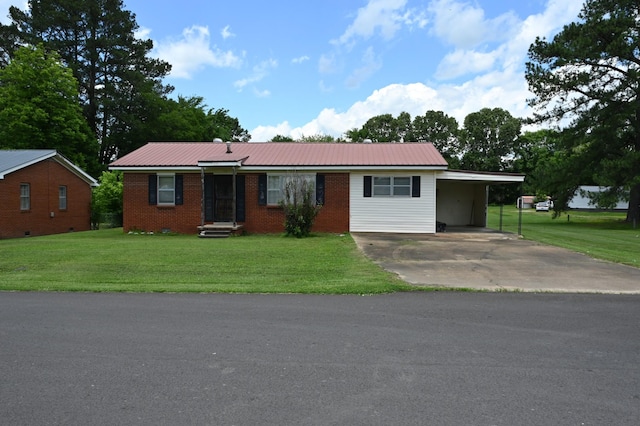 148 W Fourth Ave, Lobelville, TN 37097 - ranch-style house with driveway, brick siding, a carport, and a front lawn