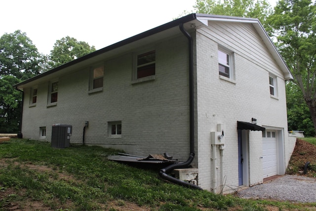762 Austin Bottom Rd, Baxter, TN 38544 - rear view of property featuring central AC unit, a garage, and brick siding
