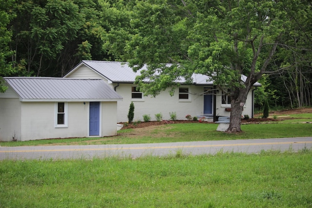 762 Austin Bottom Rd, Baxter, TN 38544 - ranch-style house with metal roof, a front lawn, and concrete block siding