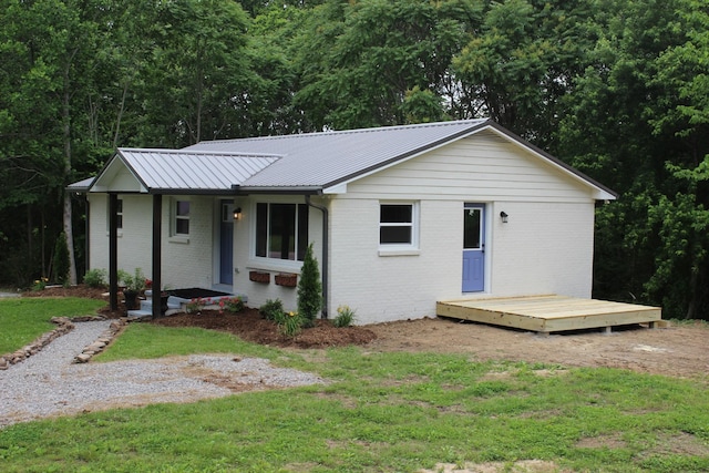 762 Austin Bottom Rd, Baxter, TN 38544 - single story home with brick siding, a front lawn, metal roof, and covered porch