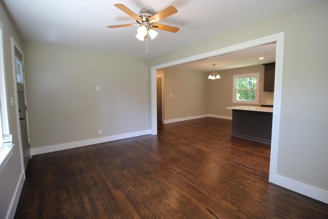 762 Austin Bottom Rd, Baxter, TN 38544 - empty room featuring a chandelier, a ceiling fan, dark wood-style floors, and baseboards