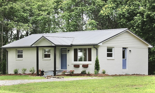 762 Austin Bottom Rd, Baxter, TN 38544 - ranch-style house featuring brick siding, a front lawn, and metal roof
