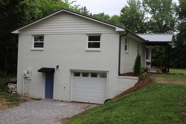 762 Austin Bottom Rd, Baxter, TN 38544 - view of home's exterior featuring a garage, driveway, brick siding, and a yard