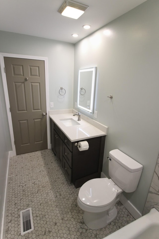 762 Austin Bottom Rd, Baxter, TN 38544 - bathroom with toilet, vanity, and baseboards