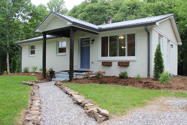 762 Austin Bottom Rd, Baxter, TN 38544 - ranch-style house featuring brick siding, a front yard, and metal roof