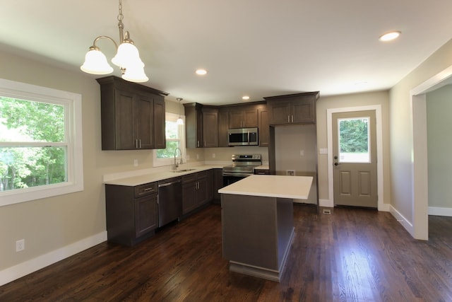762 Austin Bottom Rd, Baxter, TN 38544 - kitchen with stainless steel appliances, a sink, a chandelier, light countertops, and dark brown cabinetry
