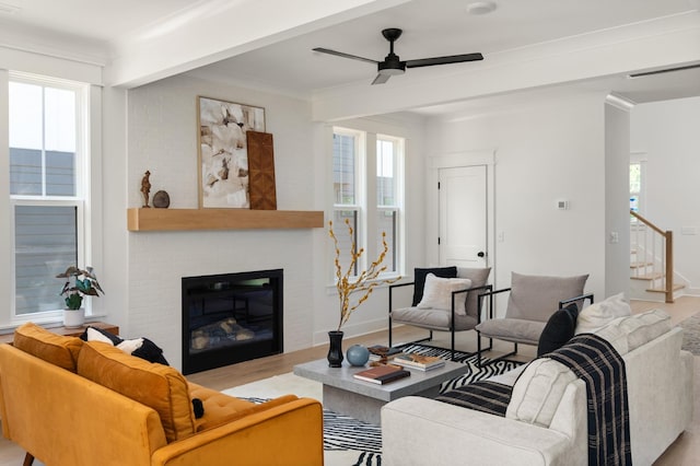 1330 Mcalpine Ave, Nashville, TN 37216 - living room with a ceiling fan, stairs, a brick fireplace, light wood finished floors, and crown molding