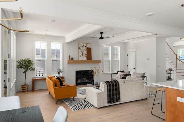 1330 Mcalpine Ave, Nashville, TN 37216 - living area featuring light wood-style floors, stairs, ceiling fan, a glass covered fireplace, and healthy amount of natural light