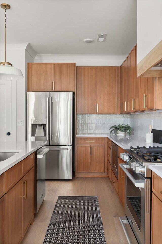 1330 Mcalpine Ave, Nashville, TN 37216 - kitchen with appliances with stainless steel finishes, light countertops, tasteful backsplash, brown cabinetry, and crown molding