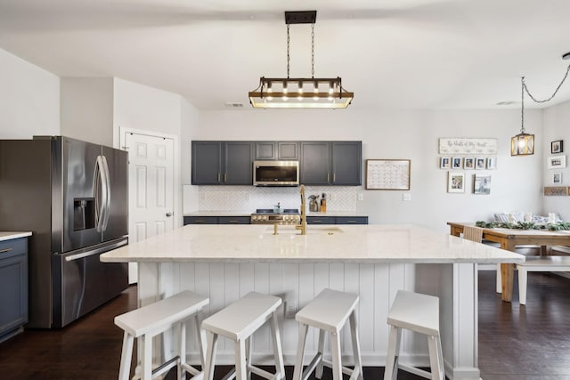390 Owl Dr, Lebanon, TN 37087 - kitchen featuring stainless steel appliances, a sink, decorative backsplash, light stone countertops, and dark wood finished floors