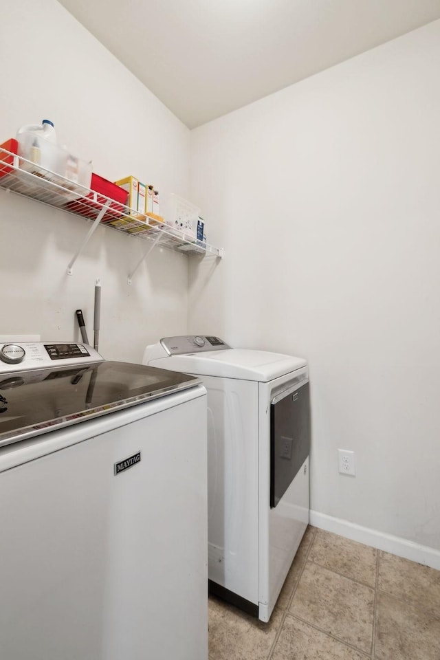390 Owl Dr, Lebanon, TN 37087 - laundry room featuring washing machine and clothes dryer, baseboards, and light tile patterned flooring