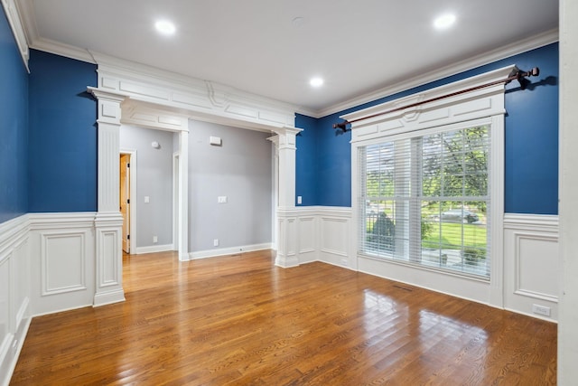 3334 Granite Springs Way, Murfreesboro, TN 37130 - empty room with decorative columns, wainscoting, wood finished floors, ornamental molding, and a decorative wall