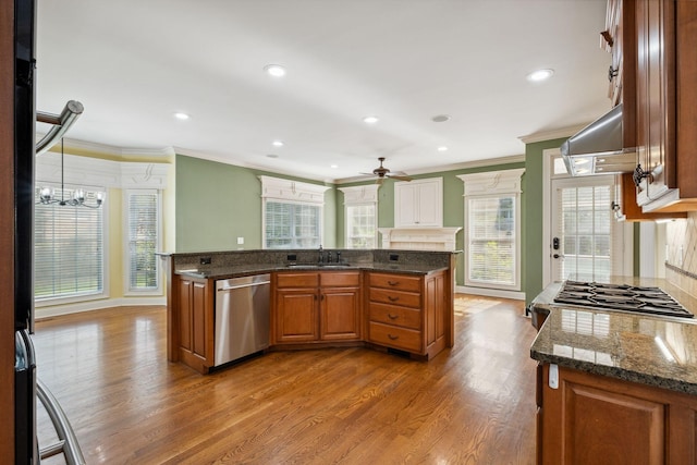3334 Granite Springs Way, Murfreesboro, TN 37130 - kitchen with stainless steel appliances, crown molding, wood finished floors, brown cabinetry, and ceiling fan