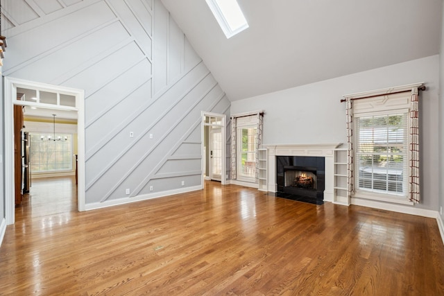 3334 Granite Springs Way, Murfreesboro, TN 37130 - unfurnished living room with a tile fireplace, wood finished floors, a skylight, a chandelier, and lofted ceiling