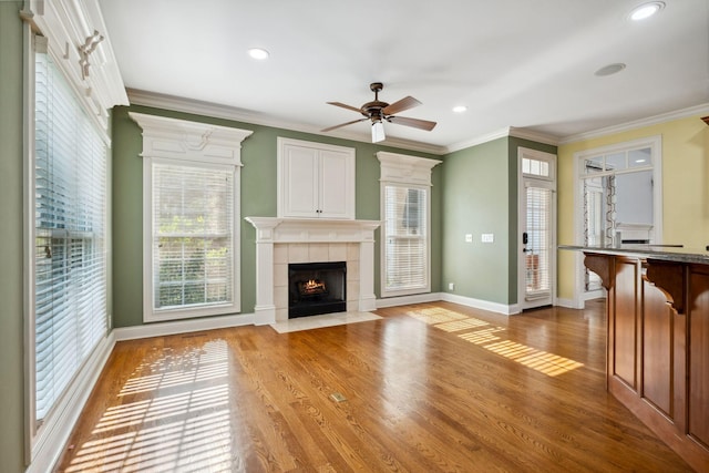 3334 Granite Springs Way, Murfreesboro, TN 37130 - unfurnished living room featuring a ceiling fan, a tile fireplace, wood finished floors, baseboards, and ornamental molding